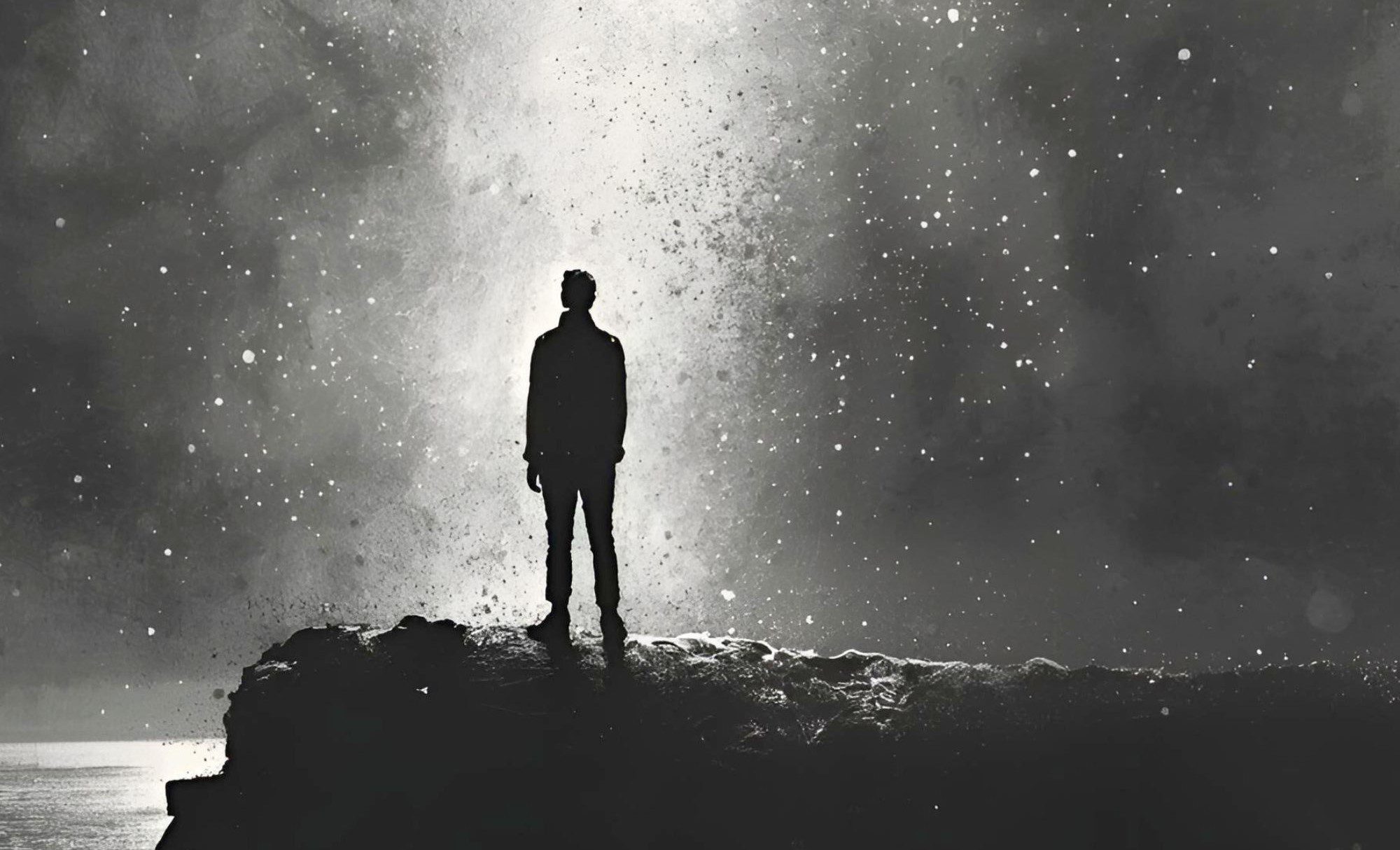 human silhouette looking up at a light filled starry sky